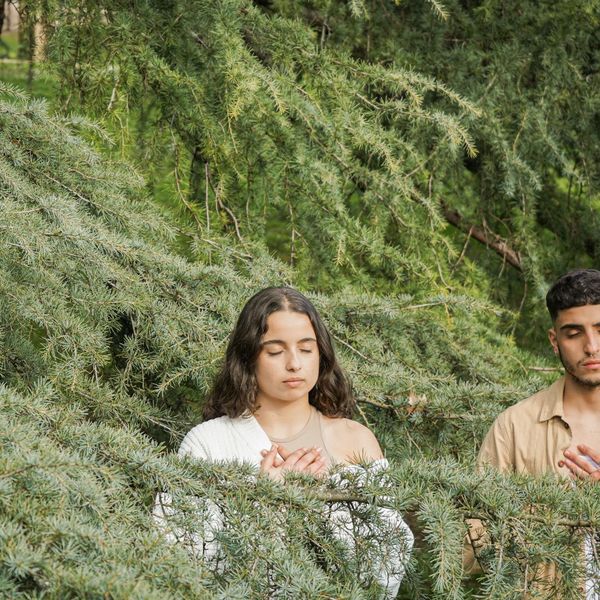 Man meditating in a calm natural setting symbolizing mental balance.